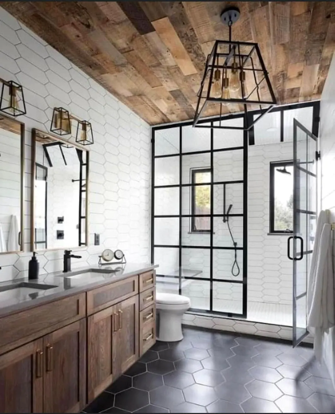 Black grid glass shower, wood vanity and a planked wood ceiling