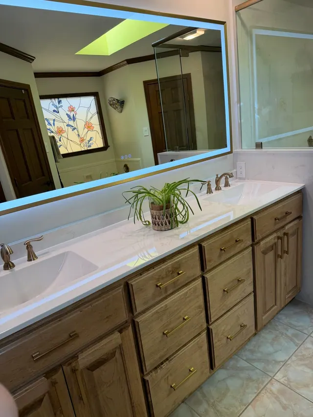 Long double vanity with a wall mirror under a skylight