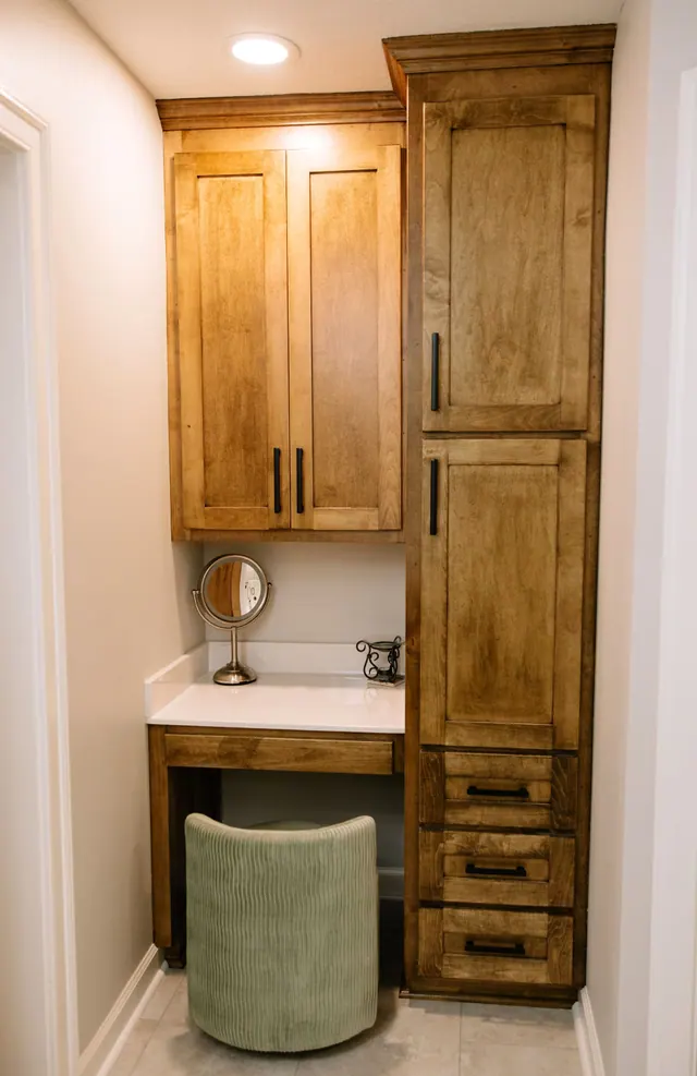 Sit-down makeup vanity built between tall alder cabinets