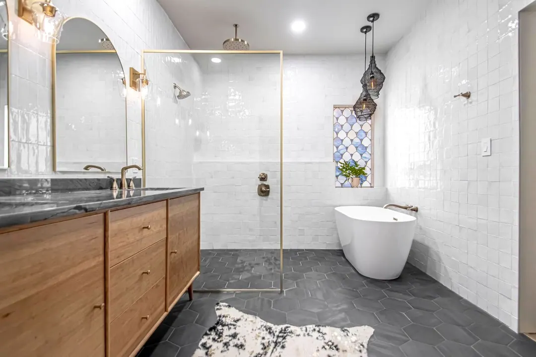 Freestanding tub and walk-in shower over a dark slate hex floor