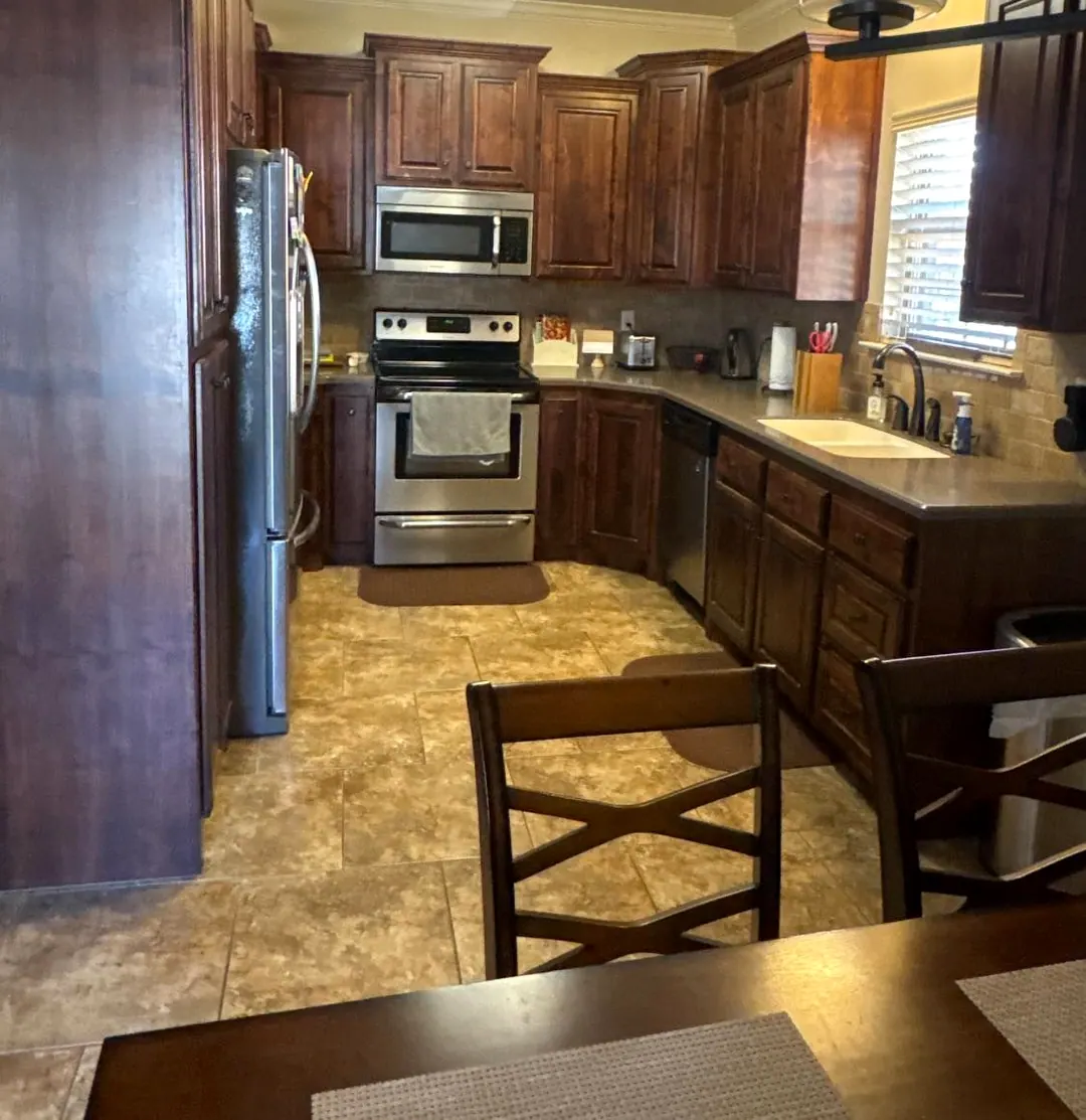 Before: Dark wood kitchen with tile floor before the remodel