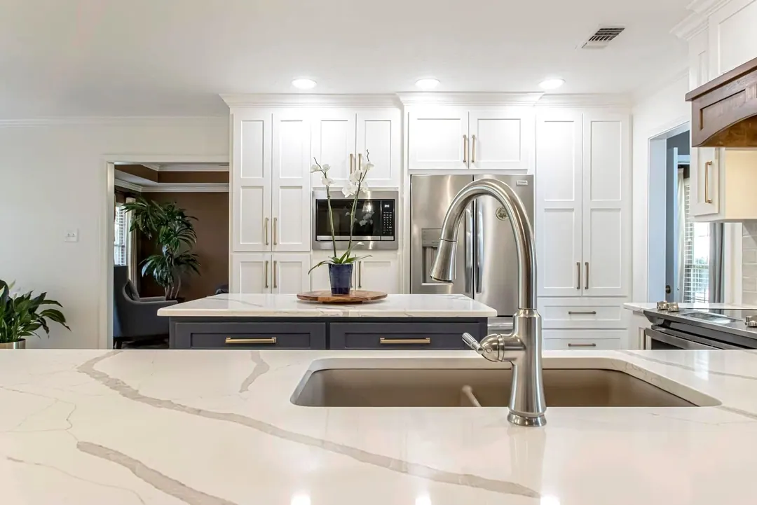 Veined quartz island with an undermount sink and arched faucet