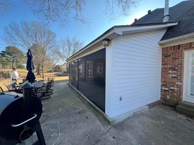 Enclosed porch addition finished in white lap siding