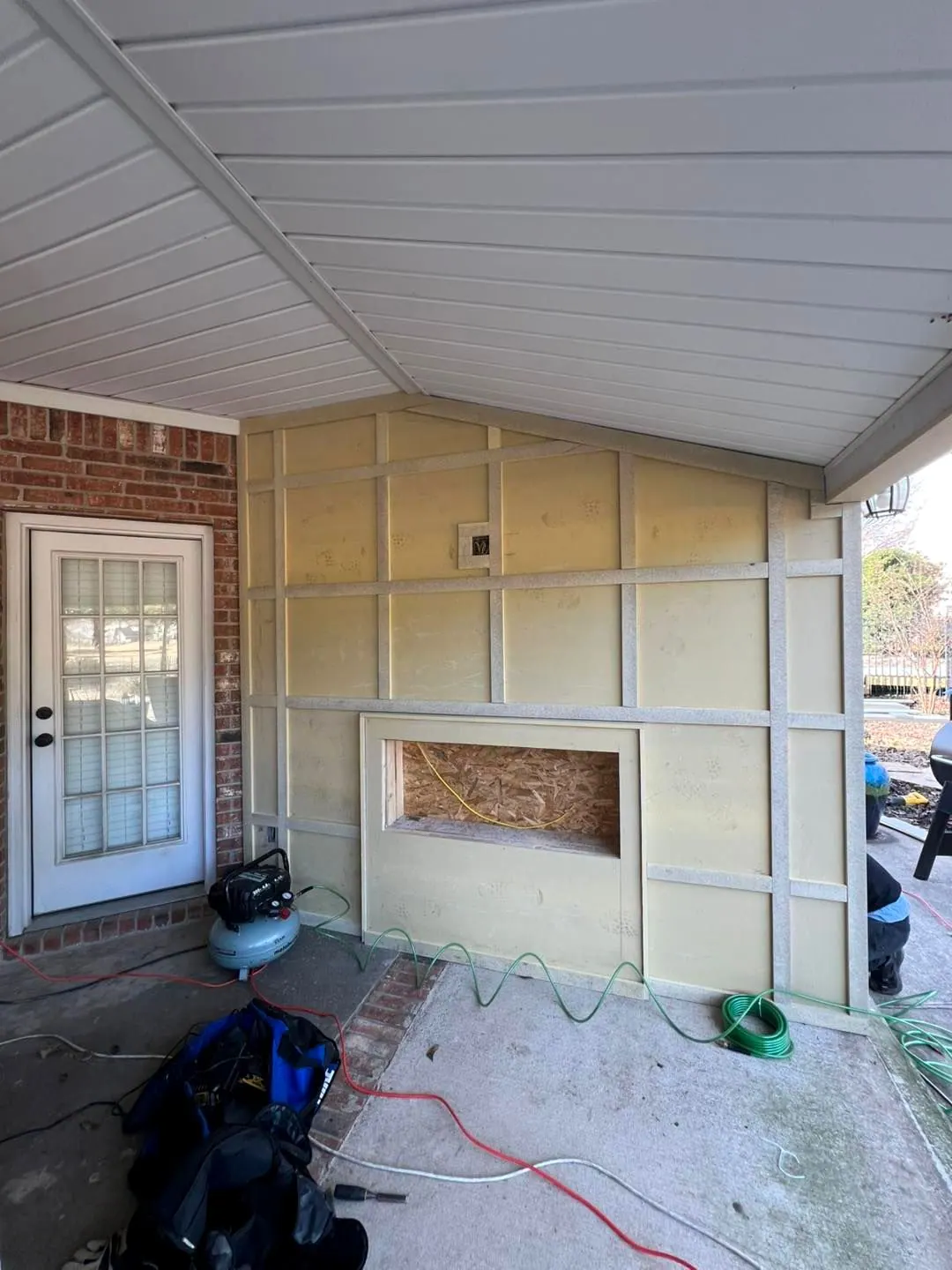 Before: The same porch wall framed and insulated before finishing