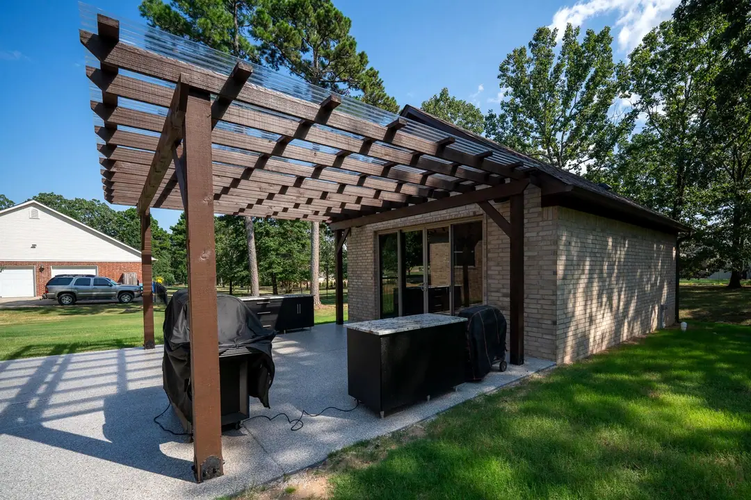 Pergola and outdoor kitchen built onto a brick workshop